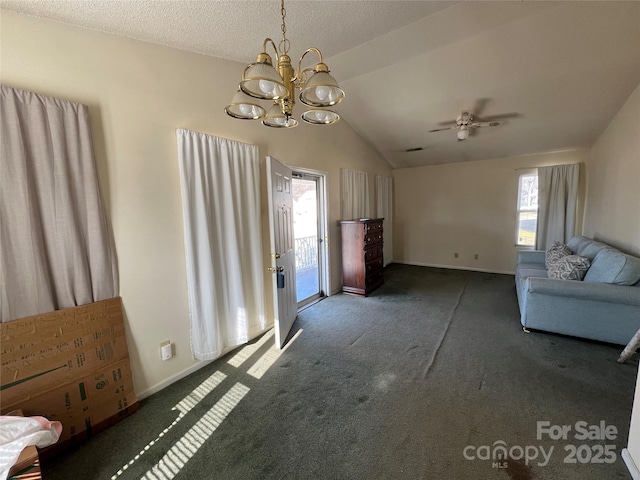 unfurnished living room featuring ceiling fan, lofted ceiling, a textured ceiling, and dark colored carpet