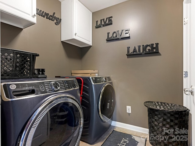 laundry room with light tile patterned floors, cabinet space, baseboards, and separate washer and dryer