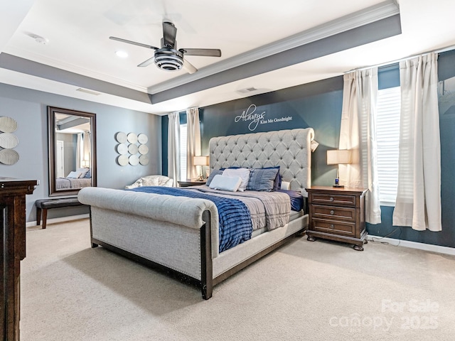 carpeted bedroom featuring baseboards, a tray ceiling, and ornamental molding