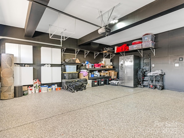 garage featuring stainless steel fridge with ice dispenser and a garage door opener