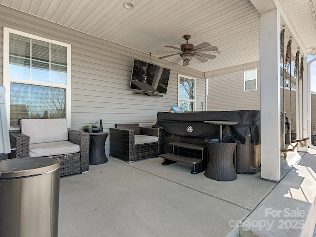 view of patio / terrace with a hot tub and a ceiling fan