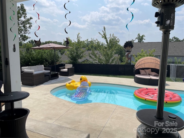 view of swimming pool with a patio area, a fenced backyard, outdoor lounge area, and a fenced in pool