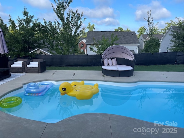 view of pool with a patio area, a fenced backyard, an outdoor living space, and a fenced in pool