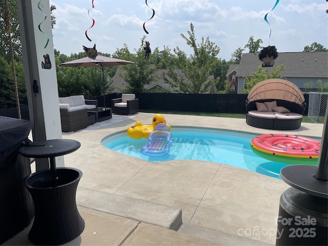 view of pool featuring a fenced in pool, a fenced backyard, an outdoor hangout area, a patio area, and central AC