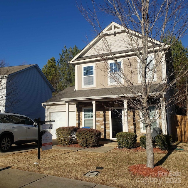 front facade featuring a garage and a front lawn