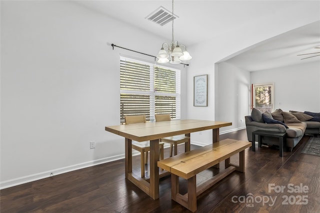 dining area featuring dark hardwood / wood-style floors and a notable chandelier