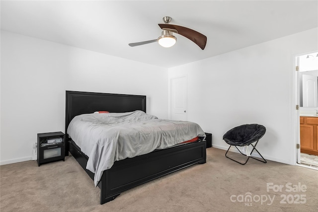 bedroom with light colored carpet, ceiling fan, and ensuite bathroom