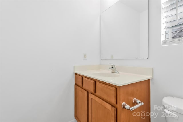 bathroom featuring vanity and toilet