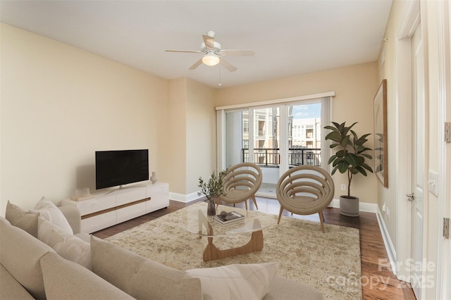 living room featuring dark hardwood / wood-style floors and ceiling fan