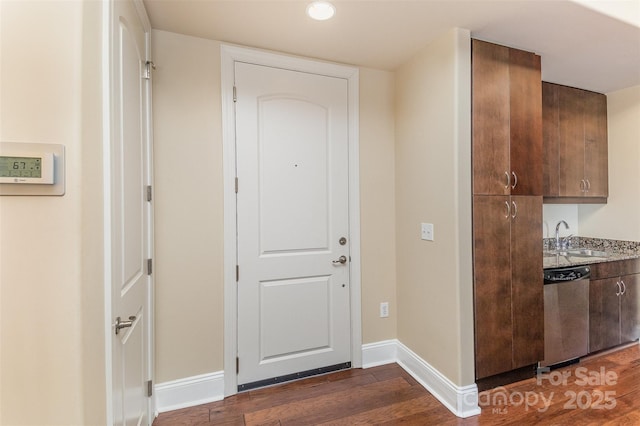 interior space with sink and dark wood-type flooring