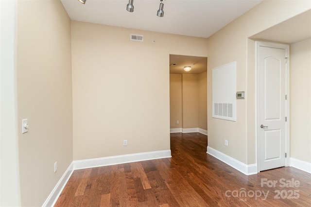 unfurnished room featuring dark wood-type flooring