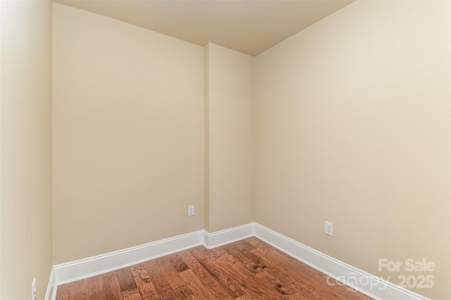 unfurnished room with hardwood / wood-style flooring