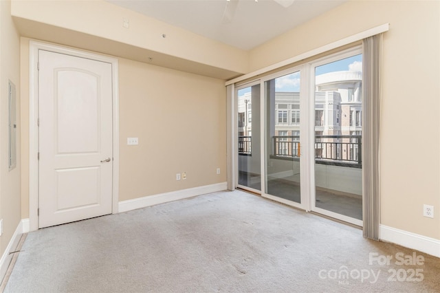 spare room with light colored carpet and ceiling fan