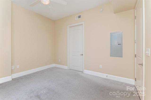 carpeted spare room with electric panel and ceiling fan