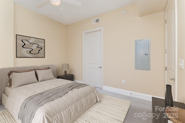 carpeted bedroom with ceiling fan and electric panel