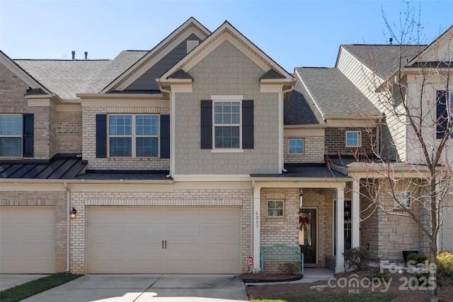 multi unit property featuring brick siding, driveway, an attached garage, and a shingled roof