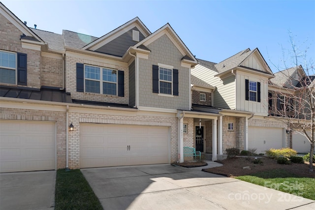 multi unit property featuring a garage, brick siding, board and batten siding, and concrete driveway