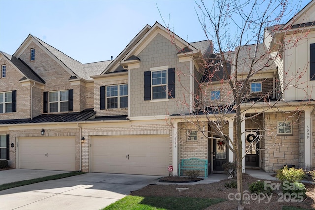 townhome / multi-family property with a standing seam roof, a garage, brick siding, and driveway