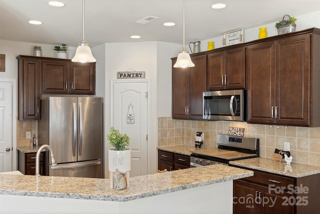 kitchen with dark brown cabinets, visible vents, and appliances with stainless steel finishes