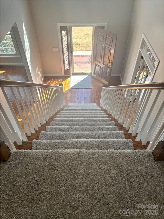 staircase featuring wood finished floors