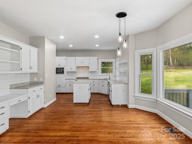 kitchen featuring white cabinets, a kitchen island, and open shelves