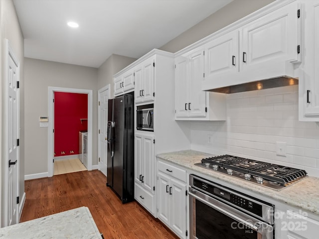 kitchen with dark wood-style flooring, backsplash, white cabinets, light stone countertops, and black appliances