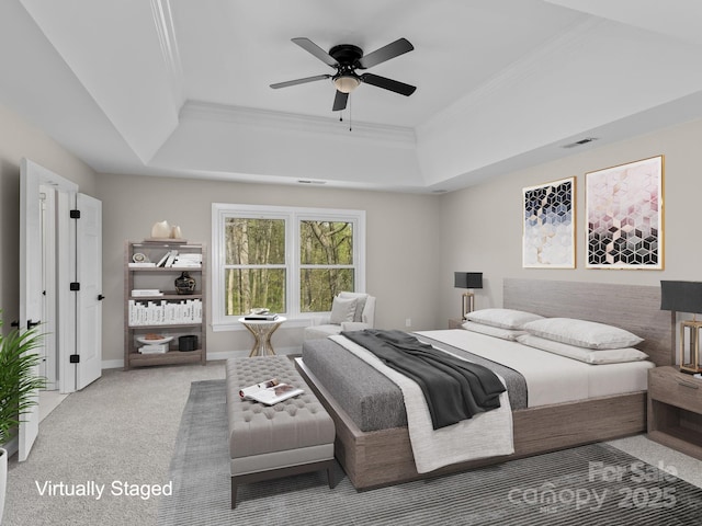 bedroom with carpet floors, a raised ceiling, visible vents, and crown molding