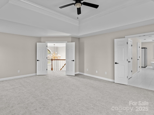 spare room with light carpet, crown molding, baseboards, and ceiling fan with notable chandelier