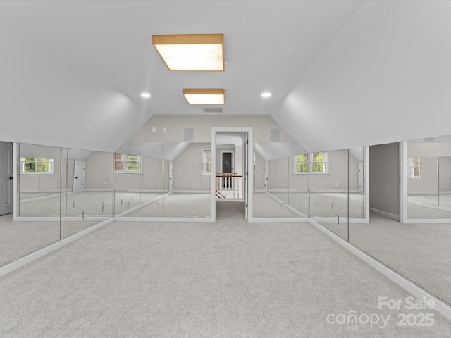 bonus room featuring recessed lighting, light colored carpet, vaulted ceiling, and visible vents