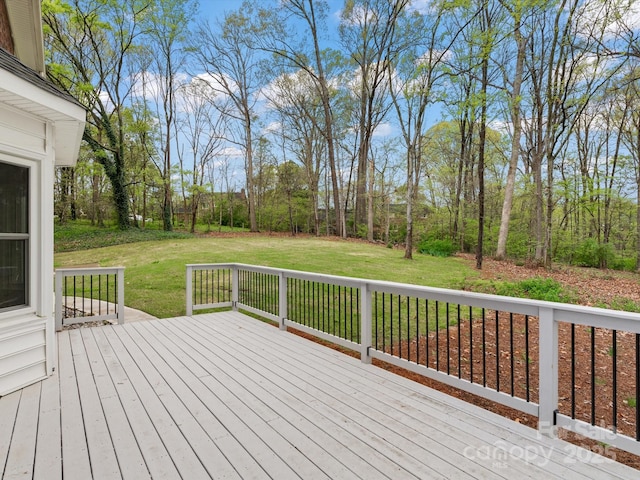 wooden deck featuring a yard