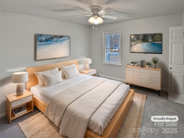 bedroom featuring ceiling fan, carpet flooring, and a textured ceiling