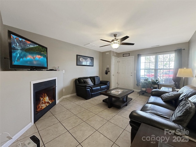 tiled living room with ceiling fan