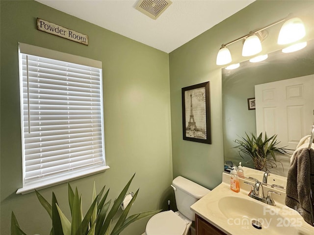 bathroom with vanity and toilet