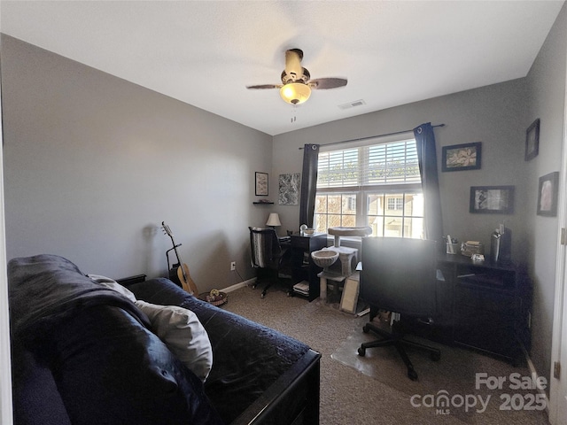 carpeted office with lofted ceiling and ceiling fan