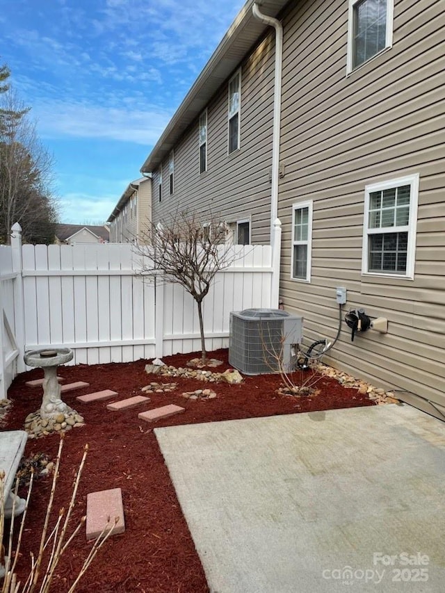 view of yard with a patio and central air condition unit