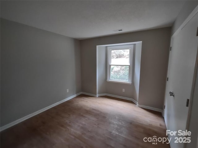 unfurnished room with light wood-type flooring