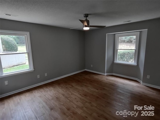 empty room with hardwood / wood-style floors and ceiling fan