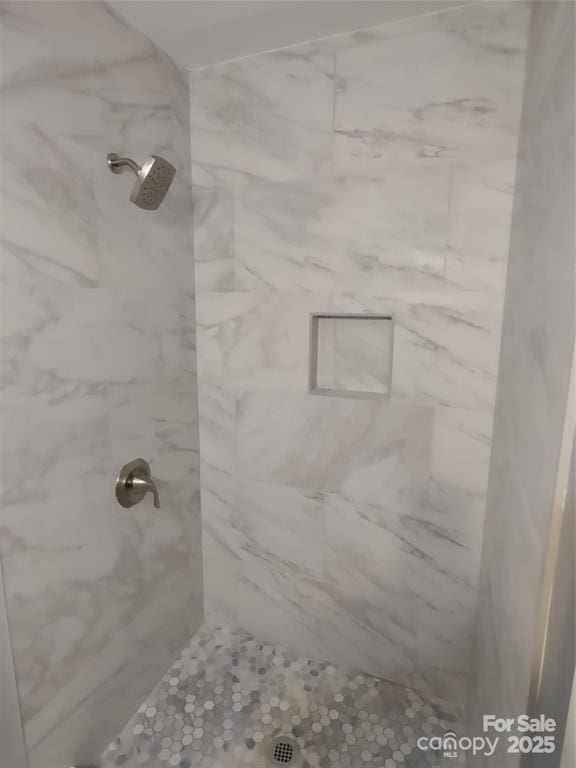 bathroom with a tile shower