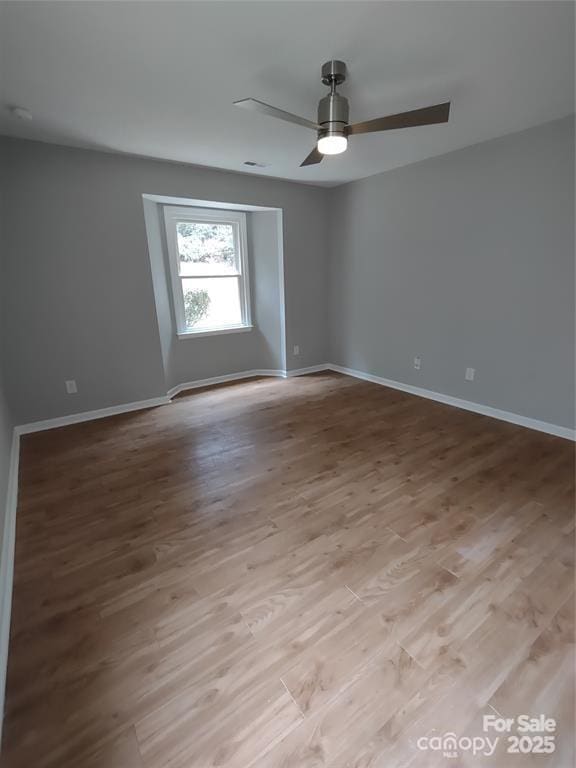 empty room with light hardwood / wood-style flooring and ceiling fan