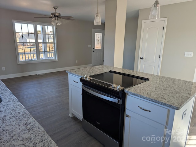 kitchen with decorative light fixtures, light stone countertops, white cabinetry, and stainless steel electric stove