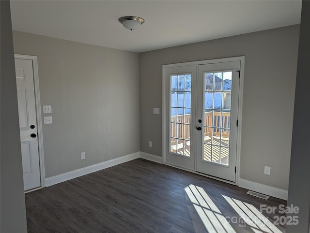 doorway with dark wood-style floors, french doors, visible vents, and baseboards