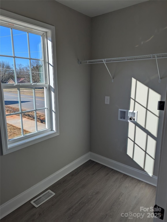 laundry area with laundry area, dark wood-type flooring, washer hookup, visible vents, and baseboards