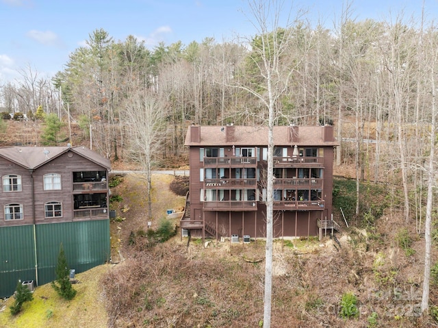 rear view of property featuring a balcony