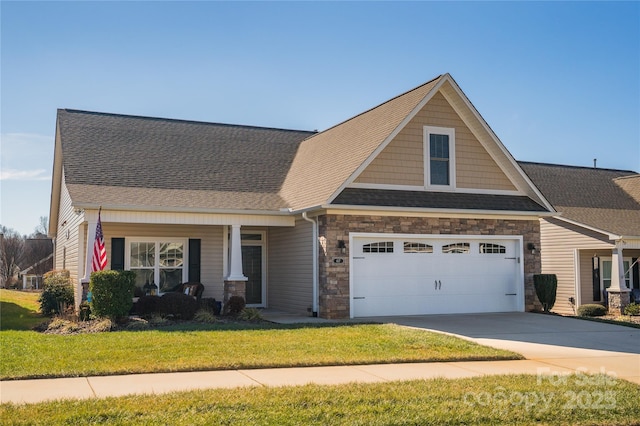 craftsman-style home featuring a garage, a front lawn, and a porch