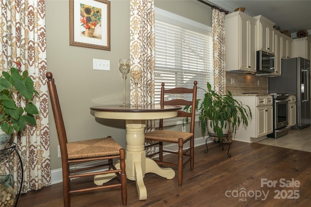 dining space featuring dark hardwood / wood-style floors