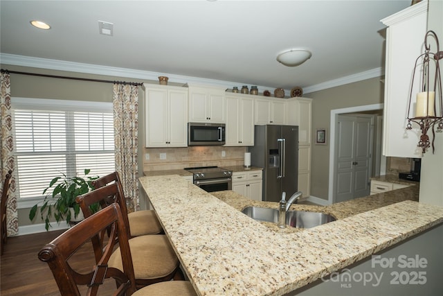 kitchen with sink, appliances with stainless steel finishes, kitchen peninsula, light stone countertops, and decorative backsplash