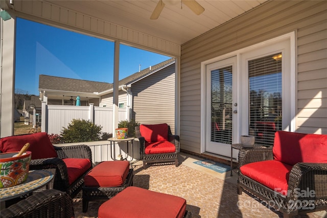 sunroom featuring ceiling fan