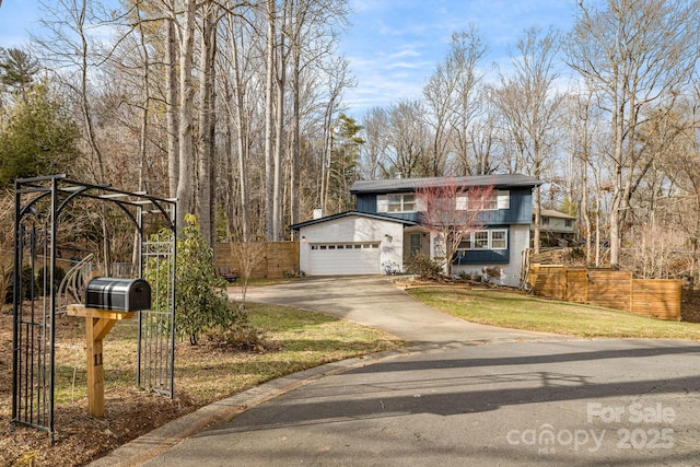 view of front of property with a garage and a front lawn