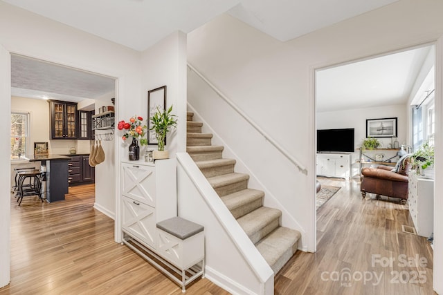 stairway with hardwood / wood-style flooring