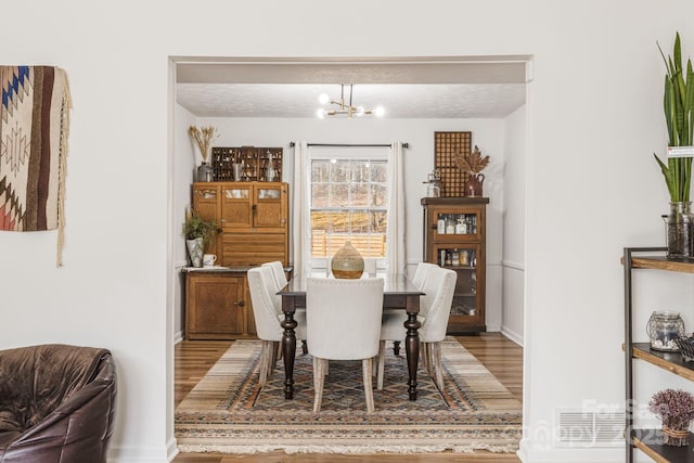 dining space featuring a notable chandelier and hardwood / wood-style floors